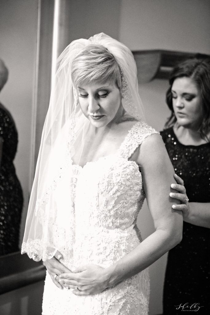 black and white photograph of bride getting ready