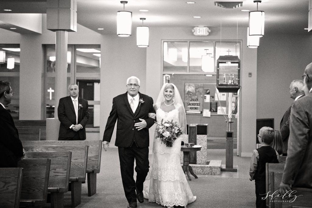 bride and father of bride walking her down the aisle