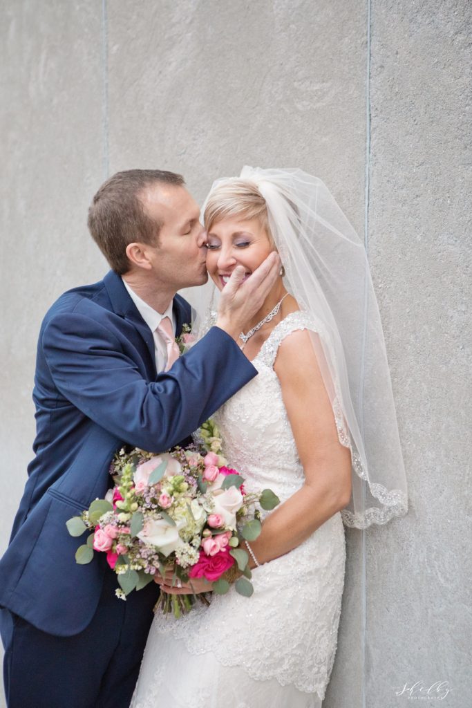 groom kissing bride's cheek