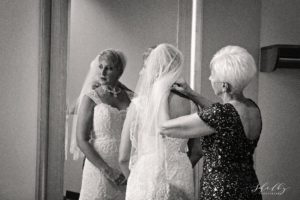 bride's mother adjusting veil