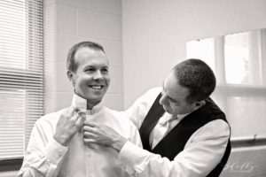 best man adjusting groom's tie